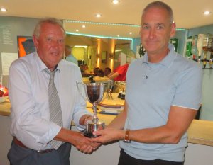 Tim Dye is presented with the Jubilee Trophy by Bob Moss