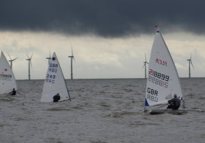 Tim Dye, Simon Clarke, and Ken Potts, head off into a murky North Sea at the start of the race