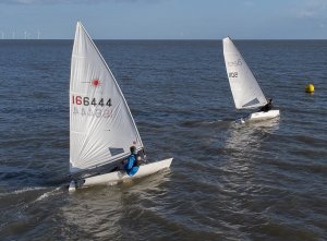 John Tappenden in his RS Aero slips past Jono Dunnett in his Laser