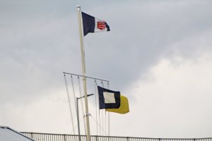 The signal flags under a grey sky