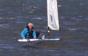 Andy Dunnett climbs back in his Laser after capsizing