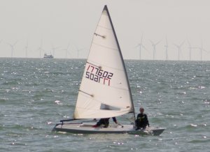 Adam, with Annabelle on the foredeck, romping back to the finish line