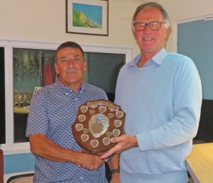 The Senior Leading Helm, Ken Potts receives the shield from Vice Commodore Robert Mitchell