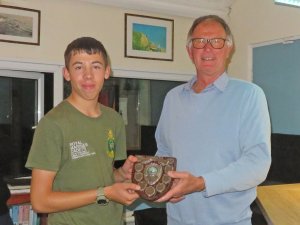 Cadet Adam Kedge is presented with the Junior Leading Helm Shield from the Club's Vice Commodore