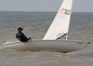 Catching a gust on the reach out to Seaward - Adam Kedge in his Laser