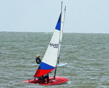 Andy Dunnett in his Laser leads Finley Taylor in his Topper