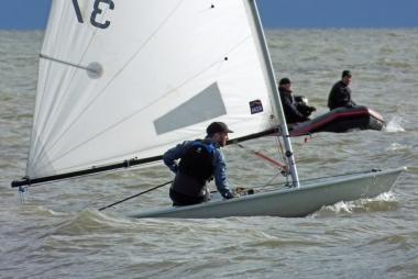 Andy Cornforth drives his Laser on the beat to the first mark