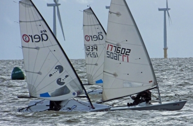  Adam Kedge, in his Laser, is challenged by two RS Aeros