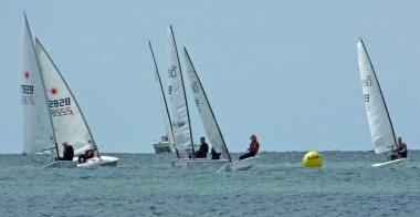 Some of the dinghies head from Lilley Farm buoy to the finish line