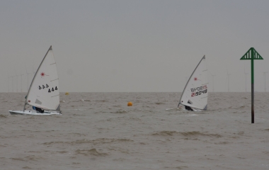 Andy Dunnett leads the Laser Radial start, with Paul Stanton on his heels